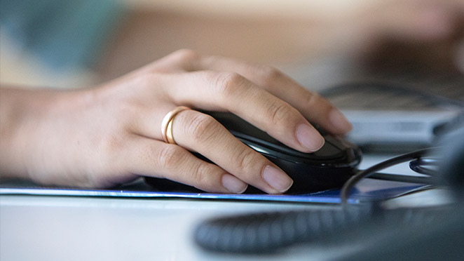 Closeup of hand on computer mouse device